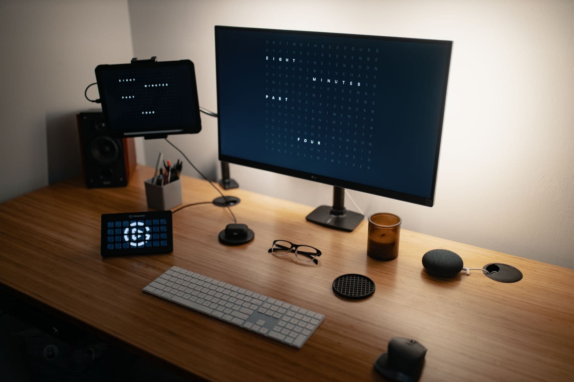 From above of flat screen computer and keyboard placed on wooden table with modern gadgets and monitors in workspace